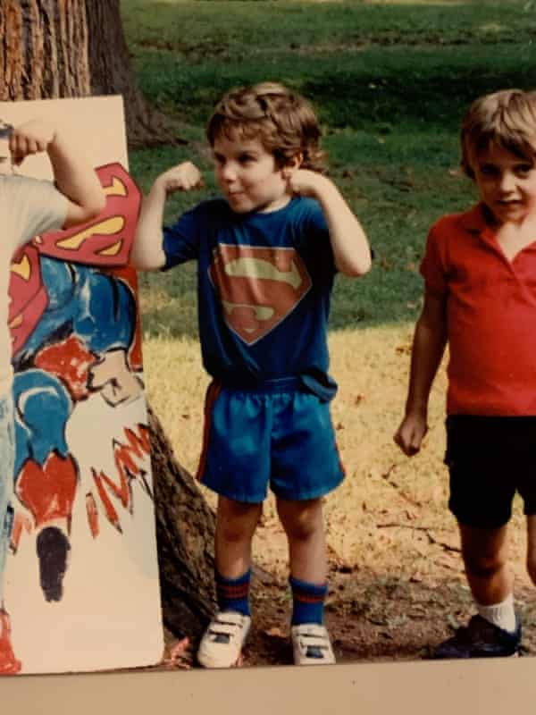 Matthew Cantor making a muscle in a Superman T-shirt