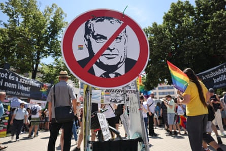 A protest placard depicts a stop sign with Orbán’s face on it at the Pride march