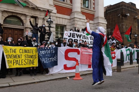 Demonstrators hold placards as they take part in a “Free Gaza” protest, near Admiralty Arch in central London, on 1 May.