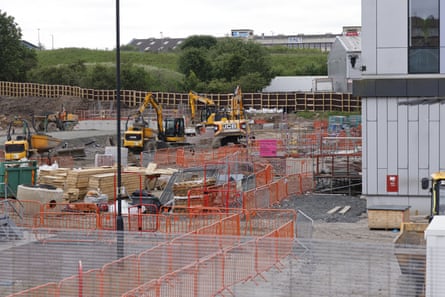 Construction work alongside a modern building