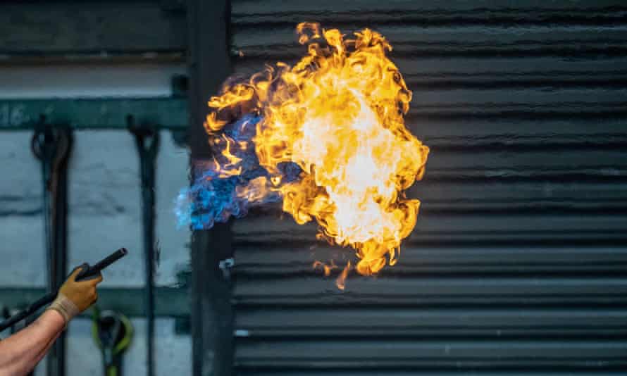 A worker uses a gas burner to prepare a casting mould at the Siempelkamp Giesserei foundry in Krefeld, Germany