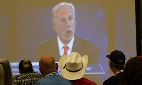 Supporters of Texas governor Greg Abbott watch his debate in McAllen on screen.