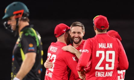 Chris Woakes celebrates with teammates as Mitchell Marsh walks off