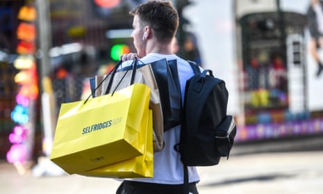 A shopper with a Selfridges bag in Oxford Street in London
