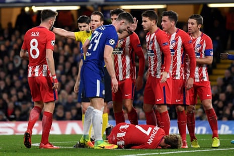 Antoine Griezmann is on the floor after colliding with Gary Cahill.