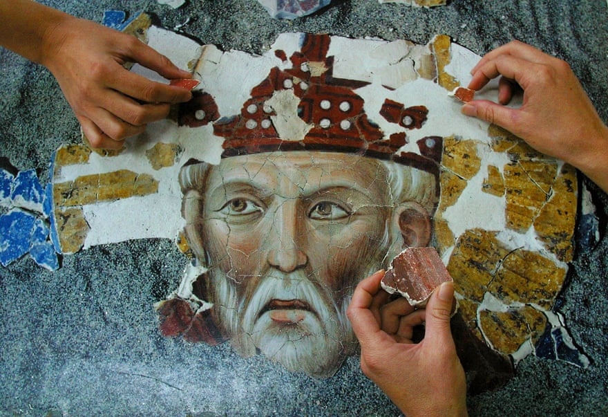 Restorers work on Giotto’s 13th-century fresco of Saint Rufus, in Assisi, Italy.