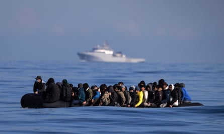 An inflatable dinghy carrying about 65 migrants crosses the English Channel in March 2024.