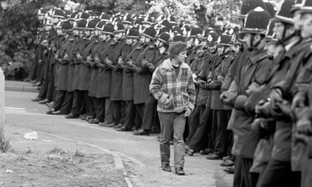 A picket inspects a line of policemen outside the Orgreave coking plant, Rotherham, in June 1984