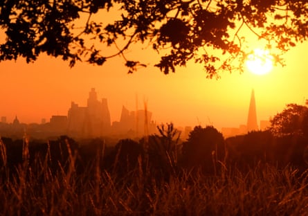 The sun rises above the London skyline in August 2022.