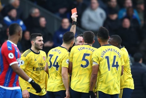 Referee Paul Tierney shows a red card to Pierre-Emerick Aubameyang of Arsenal.