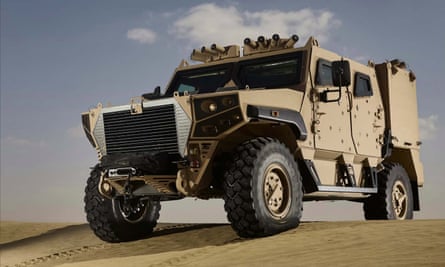A khaki-coloured armoured vehicle on the top of a dune.