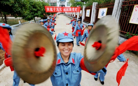 People dressed in Red Army uniforms perform in Yiyang, central Jiangxi province. The slogan reads: ‘Celebrate the 19th party congress. Always follow the party.’