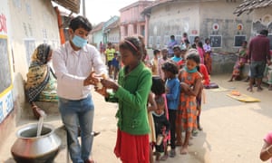 A primary school teacher instructs children on a street in Kolkata, India, on 30 November.