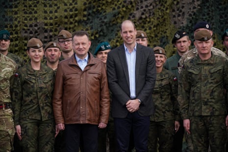 The Prince of Wales and the Polish deputy prime minister, Mariusz Blaszczak, pose for a group photo with British and Polish troops
