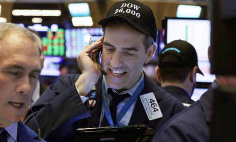 Trader Gregory Rowe wears a Dow 26,000 hat as he works on the stock exchange floor.