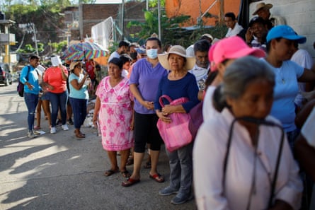 essay about mexico city People queue to receive food donations, a month after Hurricane Otis.