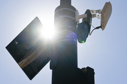 A surveillance camera mounted on a traffic pole