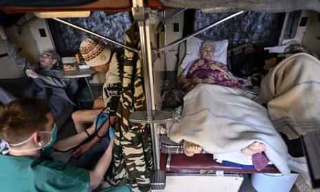 An MSF team member cares for patients on the medical evacuation train to Lviv.