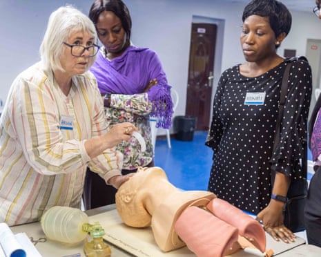 Health workers demonstrate care on a dummy