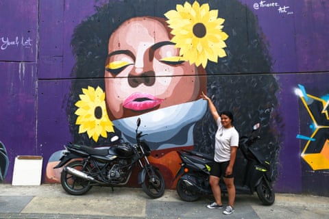 Ana Moreno and her mural, the first to be commissioned from a woman in the once conflict-ridden Comuna 13 suburb.