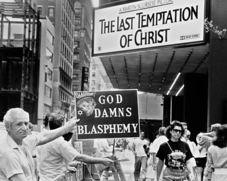 Man holds up a sign saying ‘God damns blasphemy’ outside a theatre
