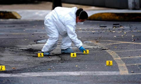 An expert works at a crime scene in Mexico City on 26 June.