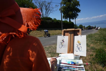 A woman draws as Fred Wright rides past on the way to Thonon-les-Bains