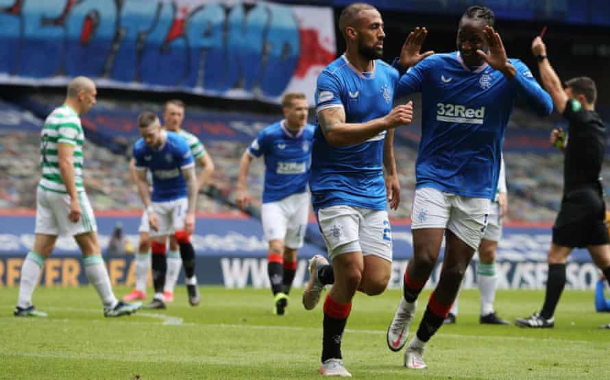 Kemar Roofe celebrates scoring Rangers’ first goal with Joe Aribo while in the background Celtic’s Callum McGregor is shown a red card by referee Nick Walsh