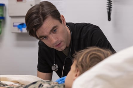 A doctor in black scrubs talking to a patient.