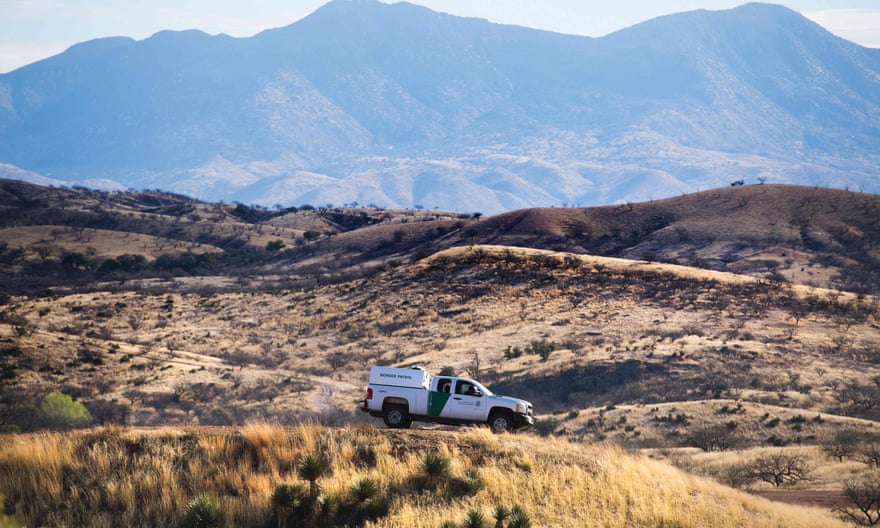 A US Border Patrol agent parks on a hill top near the border fence in Nogales, Arizona.