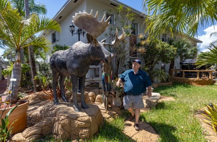 a person next to a statue of a moose