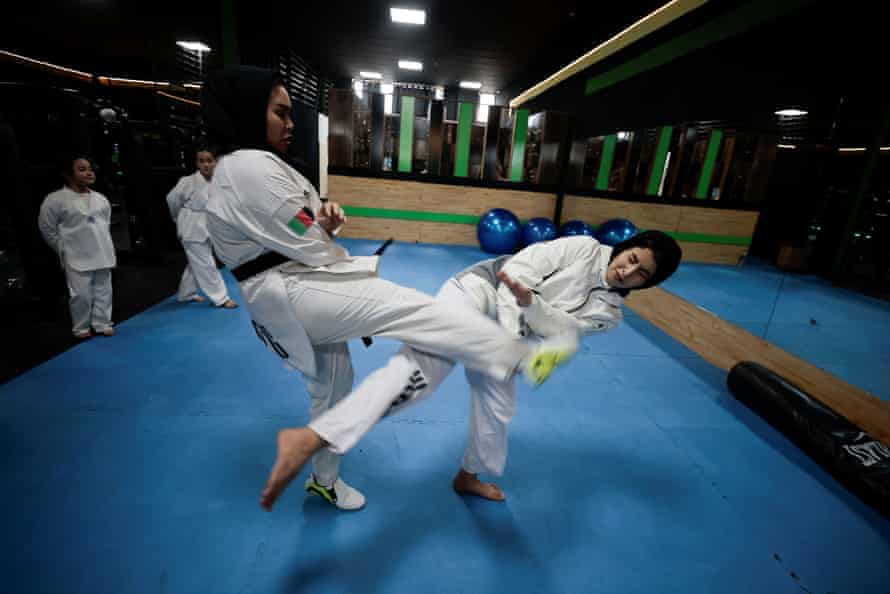 Yasamin Azizi, 21, an Afghan female athlete who trains fitness and taekwondo, trains a woman at the gym, in Kabul, Afghanistan on 2 November 2021.