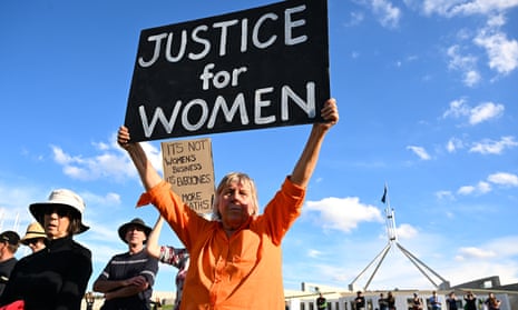 A woman holds up a sign at a rally to a call for action to end violence against women in Canberra on Sunday.