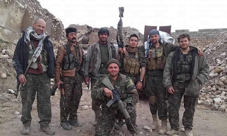 Konstandinos Scurfield (front) poses for a photograph with Kurdish fighters and other foreign volunteers in Iraq