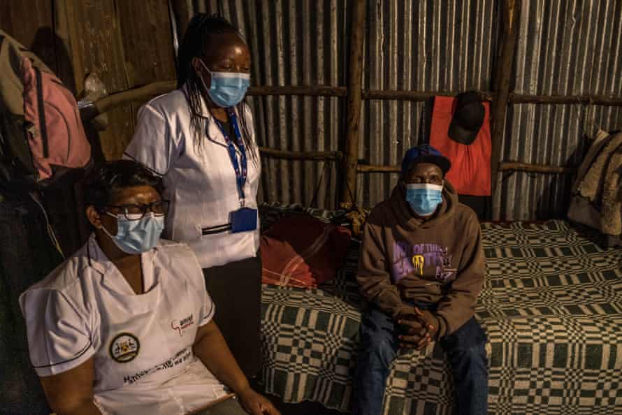 Community health workers visit a patient being treated for TB.