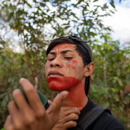 Forest Guardians paint their faces with urucum before setting off on their mission