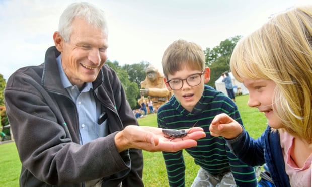 Simon Garrett, the zoo's public engagement manager, shows a Madagascan cockroach to seven-year-old Lucy and 10-year-old Freddie.
