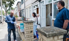 People in East Ham, London, sort out food parcels for delivery to families. 
