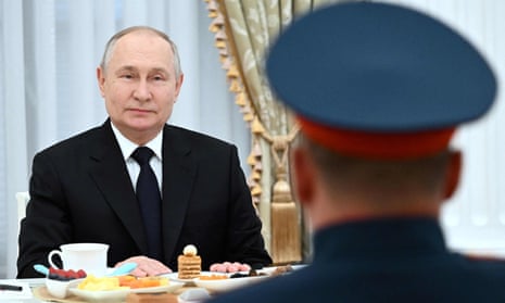 Vladimir Putin meeting Russian servicemen on Friday.