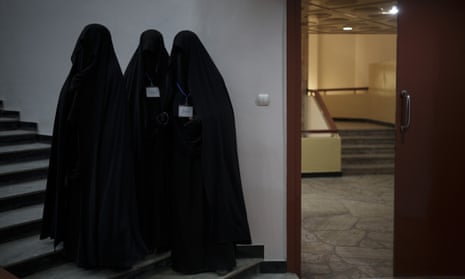Women stand inside an auditorium at Kabul University