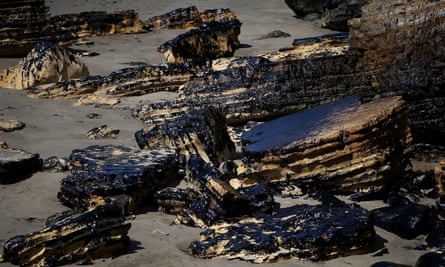 Oil covers rocks near Refugio state beach on Friday.