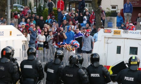 Loyalist protester throws a brick at the Police line on the Crumlin Road, Belfast during the annual Twelfth of July march. 