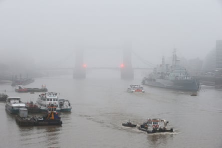 Fog shrouds Tower Bridge on the river Thames in central London.