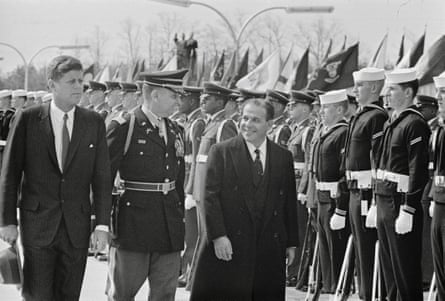 President Kennedy (left) with Lt Col Charles P Murray Jr (centre) and Brazilian president João Goulart with an honour guard behind them.