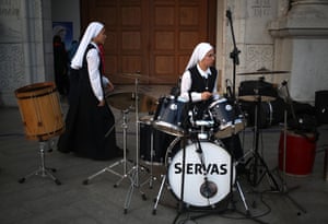 A nun practices the drums before a beatification ceremony for three slain Franciscan missionaries in Chimbote, Peru