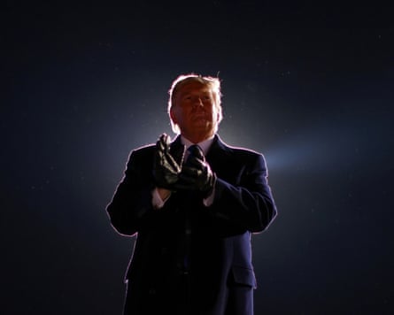 Donald Trump at a campaign rally in Omaha, Nebraska in 2020 standing in the dark with an ominous light behind him