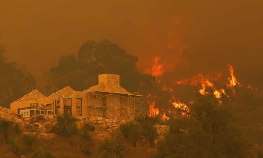 Flames surround a property under construction off Copley Road in Upper Swan on Tuesday