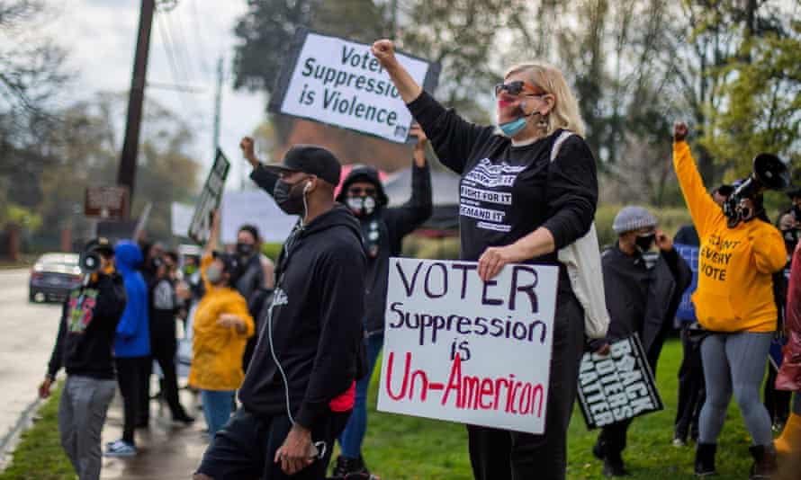 Protesters outside the governor’s mansion in Georgia on Thursday. The 98-page measure significantly curtails access to the ballot in the state.