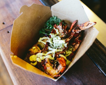 An open wooden box with seafood inside