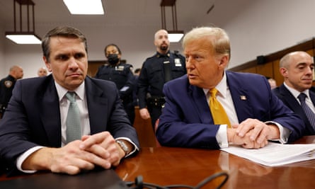 three men in suits sit at a table